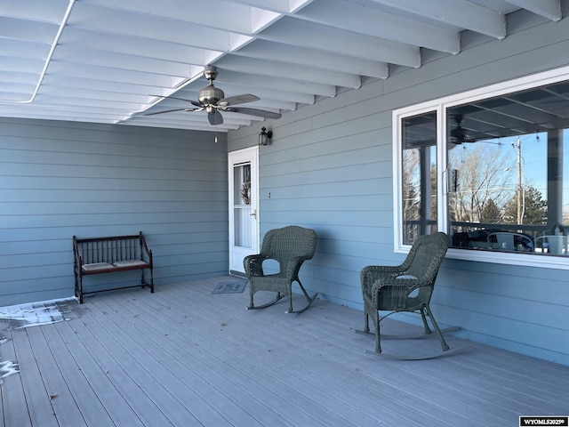 wooden deck featuring ceiling fan