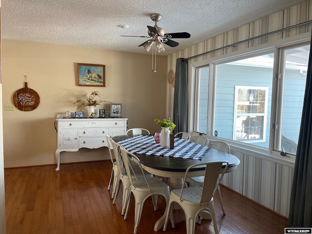 dining room featuring a textured ceiling, ceiling fan, and wood-type flooring