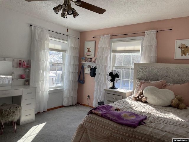 bedroom with light carpet, multiple windows, and a textured ceiling