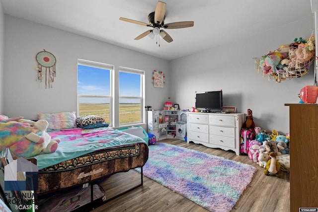 bedroom featuring wood finished floors and a ceiling fan