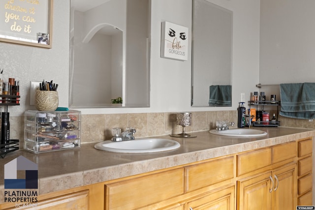 full bathroom featuring double vanity and a sink