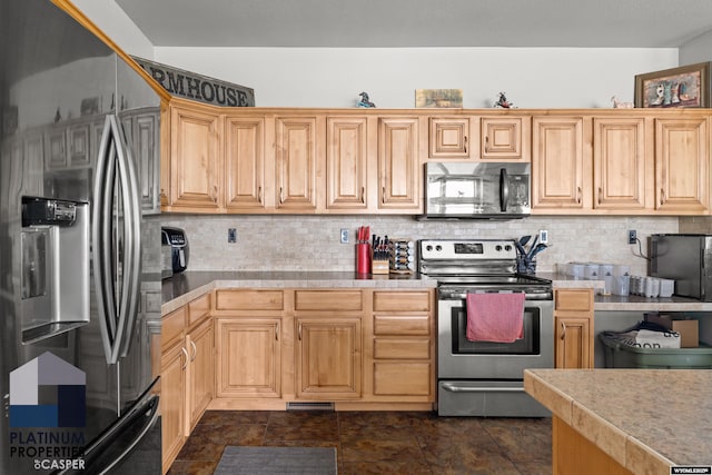 kitchen with stainless steel appliances, light countertops, and decorative backsplash