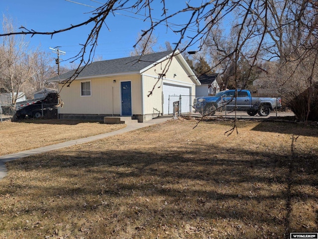 exterior space with a garage, a front yard, and fence