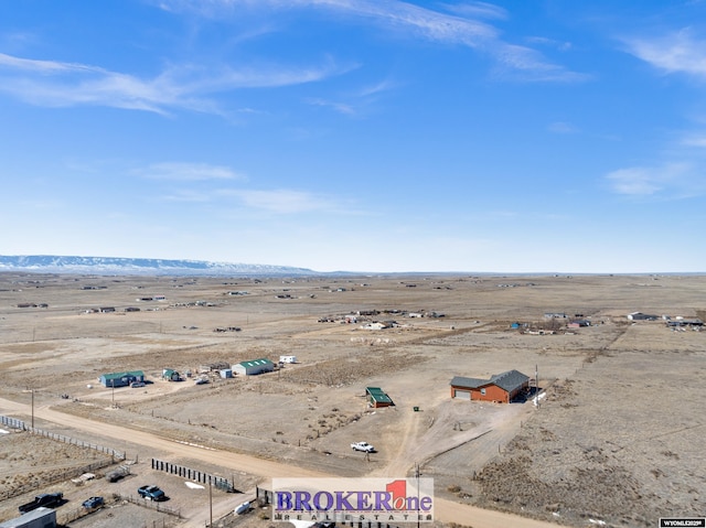 drone / aerial view featuring a mountain view, a rural view, and view of desert