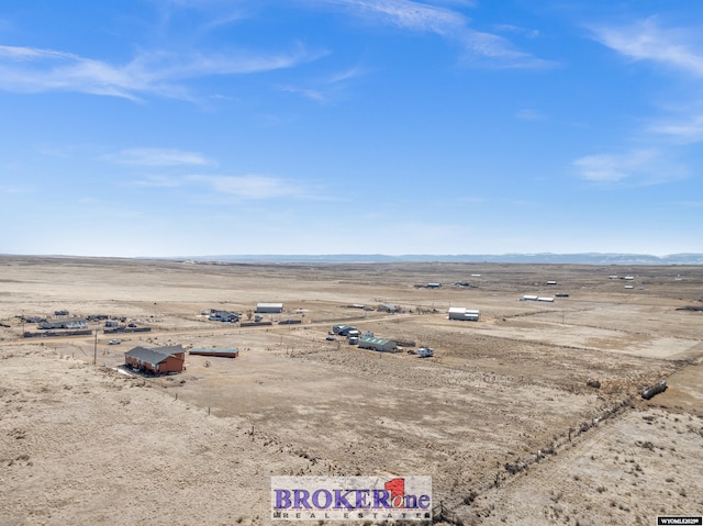 aerial view featuring a mountain view, a desert view, and a rural view