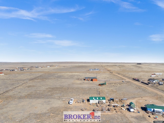 drone / aerial view featuring a rural view and view of desert