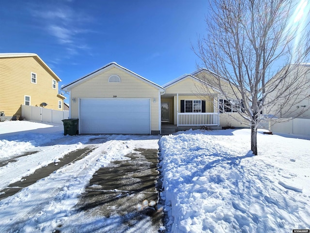 single story home with covered porch, an attached garage, and fence