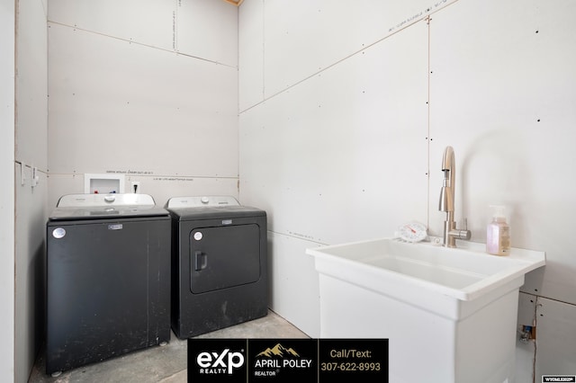 laundry area featuring laundry area, washer and clothes dryer, and a sink