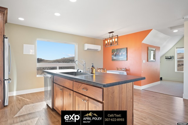 kitchen featuring a sink, light wood-style floors, an AC wall unit, appliances with stainless steel finishes, and dark countertops