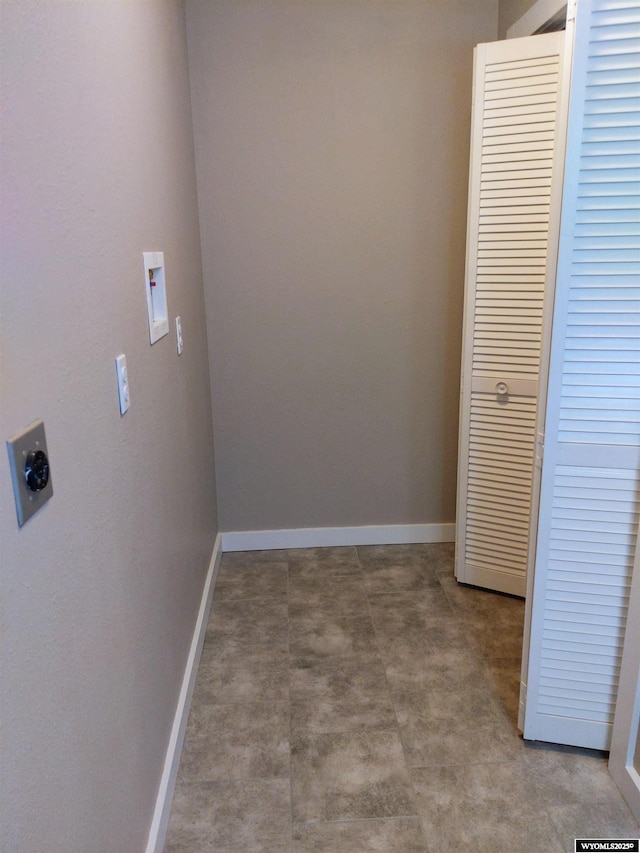 clothes washing area featuring hookup for an electric dryer and baseboards