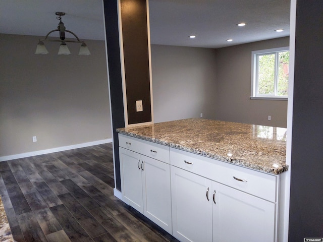 kitchen featuring light stone counters, recessed lighting, baseboards, white cabinets, and dark wood-style floors