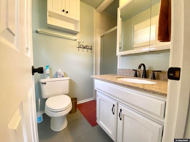 bathroom with tile patterned floors, toilet, a shower stall, baseboards, and vanity