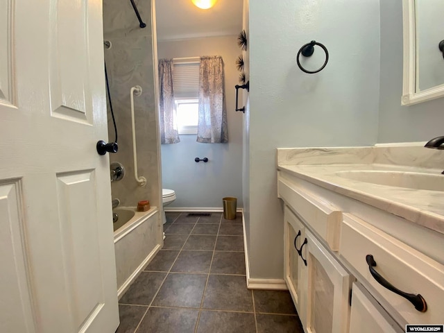 bathroom featuring tile patterned floors, toilet, washtub / shower combination, baseboards, and vanity