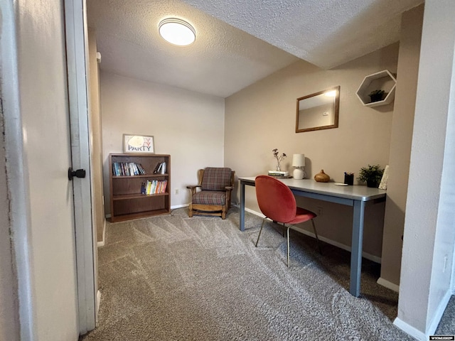 office space featuring carpet, baseboards, and a textured ceiling