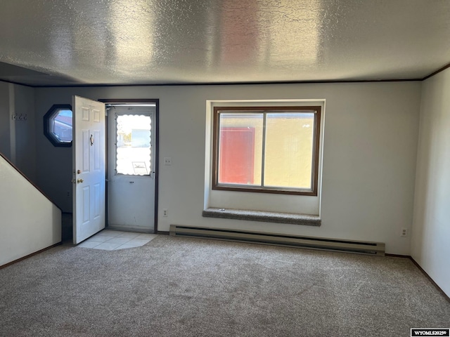 interior space with a textured ceiling, baseboards, baseboard heating, and light carpet