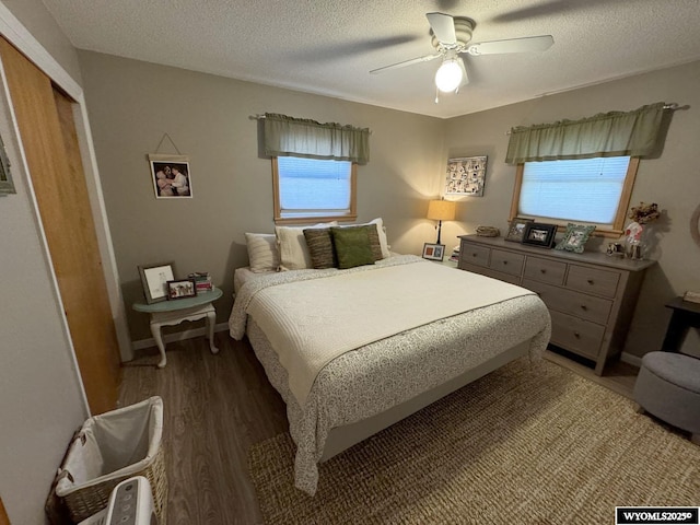 bedroom with light wood finished floors, a textured ceiling, and baseboards