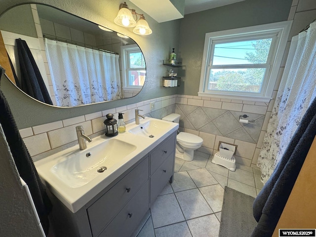 full bath featuring toilet, a wealth of natural light, and a sink