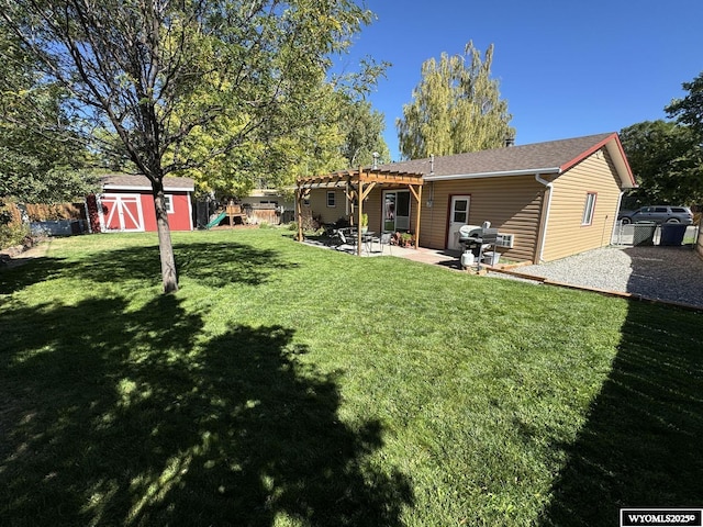 view of yard with an outbuilding, a pergola, a patio, fence, and a shed