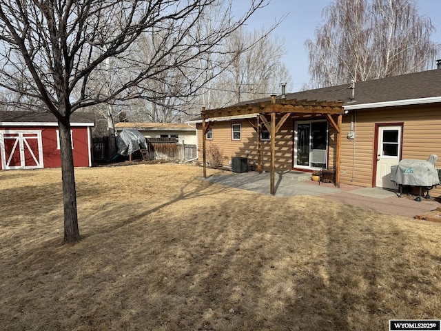 back of house with an outbuilding, cooling unit, fence, a shed, and a patio area