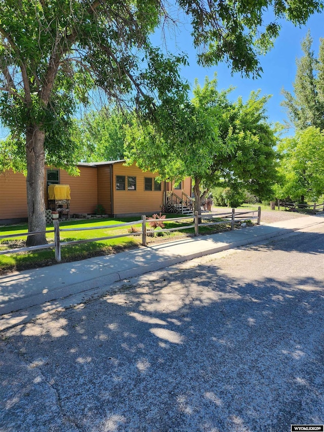 view of front of home with a fenced front yard and driveway