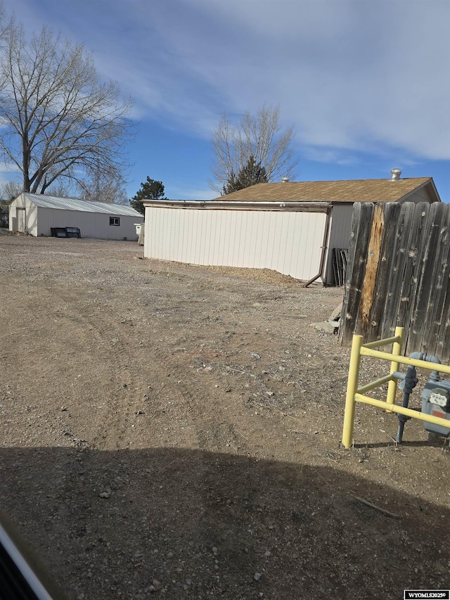 view of yard featuring an outbuilding and fence