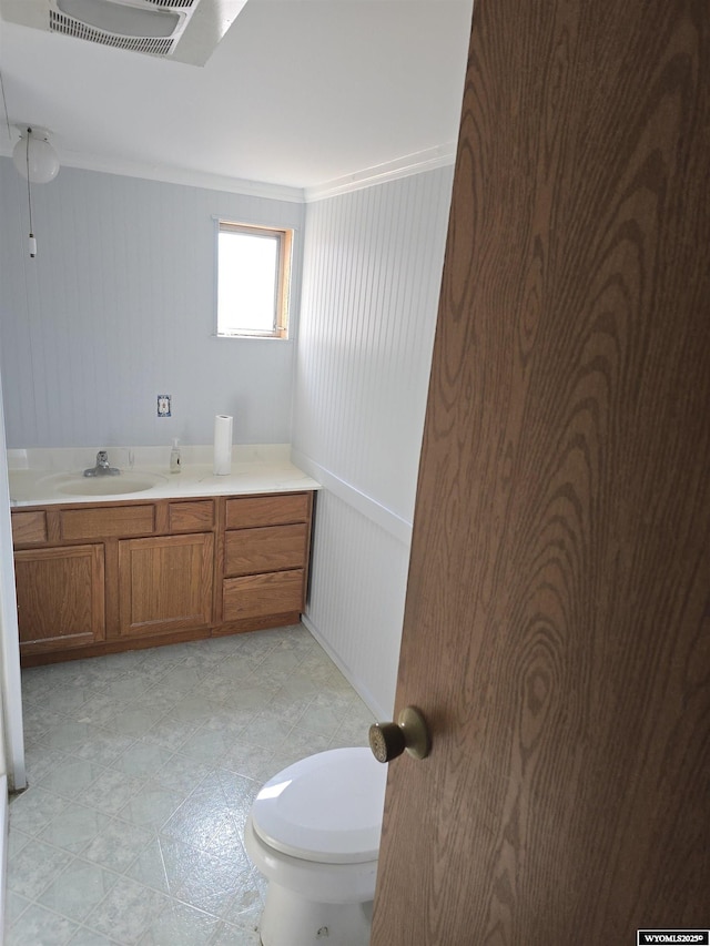 bathroom featuring visible vents, toilet, and vanity