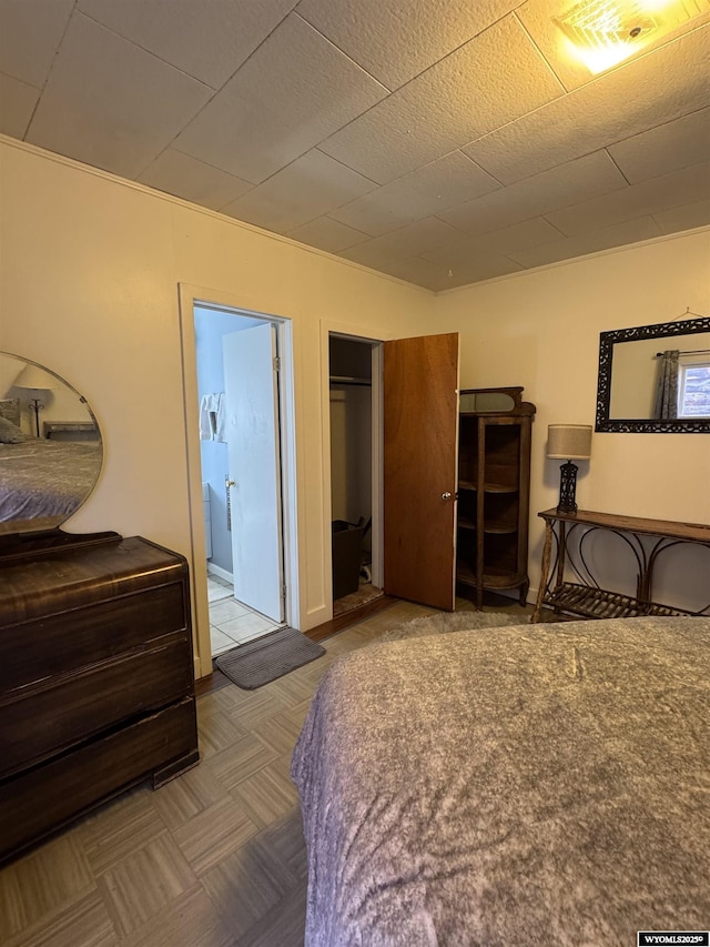 bedroom with a closet and ensuite bathroom