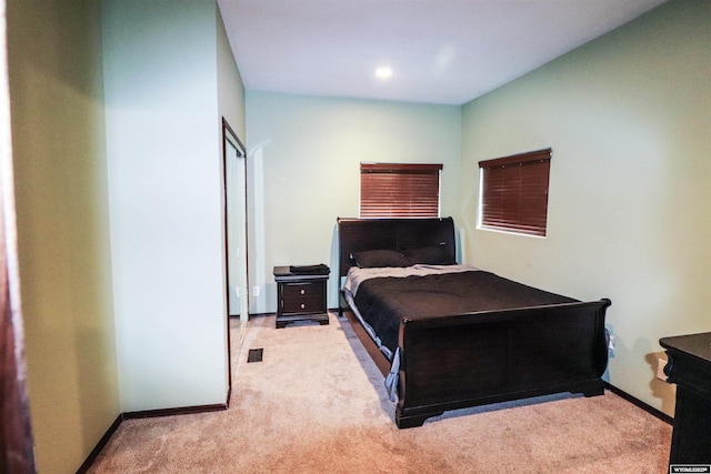 carpeted bedroom with visible vents and baseboards