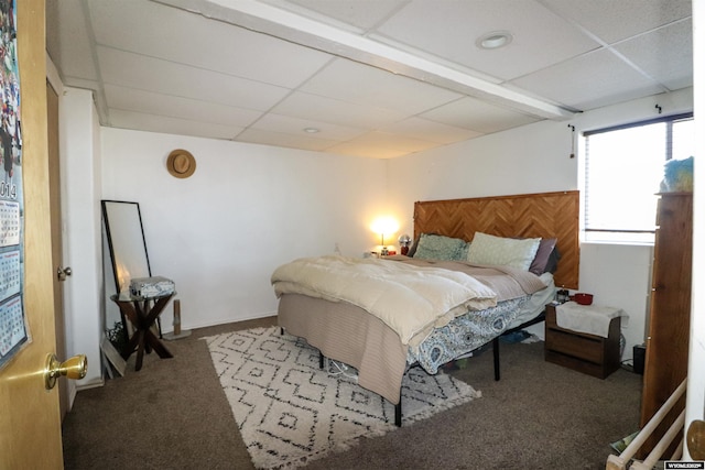 carpeted bedroom with a paneled ceiling