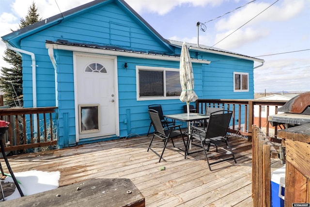 wooden deck featuring outdoor dining area