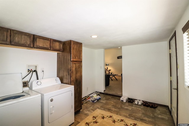 laundry area with separate washer and dryer and dark floors