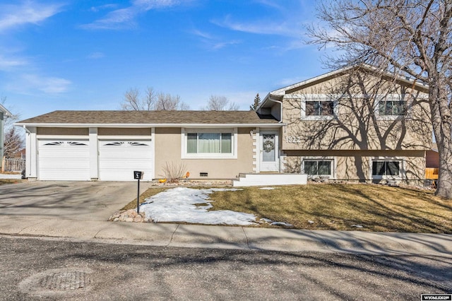 tri-level home featuring concrete driveway, an attached garage, roof with shingles, and stucco siding