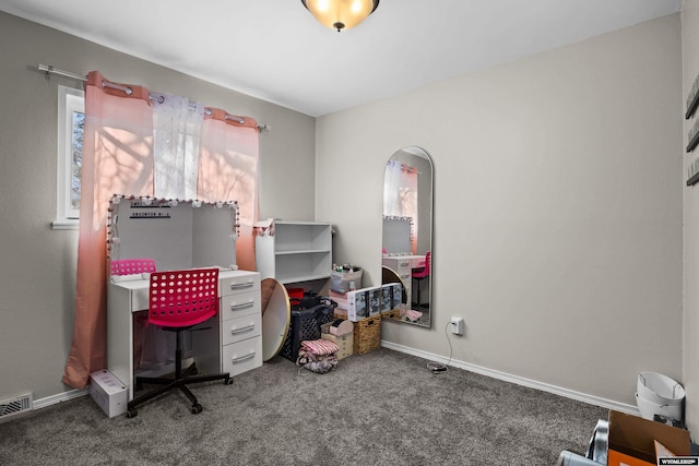 carpeted office space featuring visible vents and baseboards