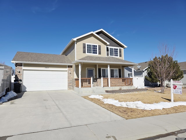 view of front facade with stone siding, a porch, concrete driveway, and a garage