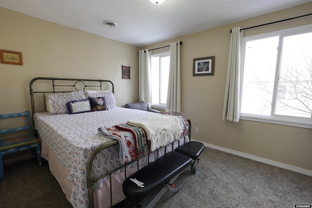 carpeted bedroom featuring visible vents and baseboards