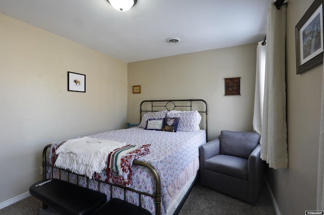 carpeted bedroom featuring baseboards and visible vents