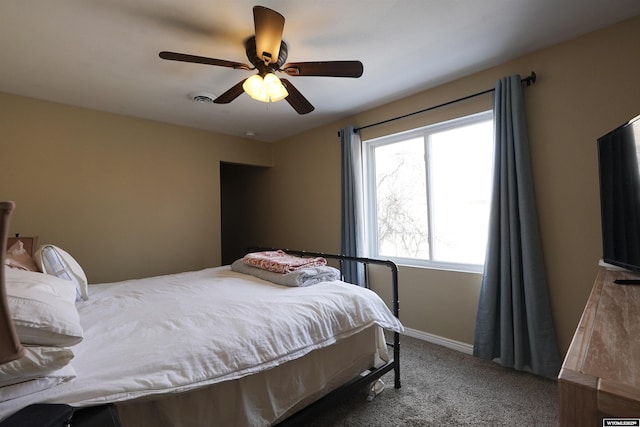 carpeted bedroom with baseboards and a ceiling fan