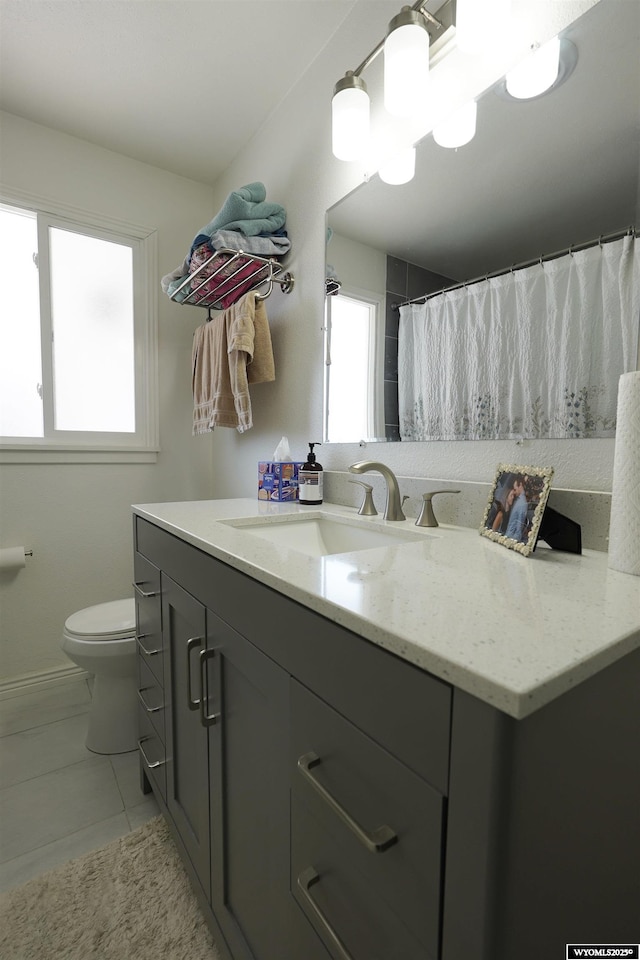 bathroom with vanity, tile patterned floors, and toilet