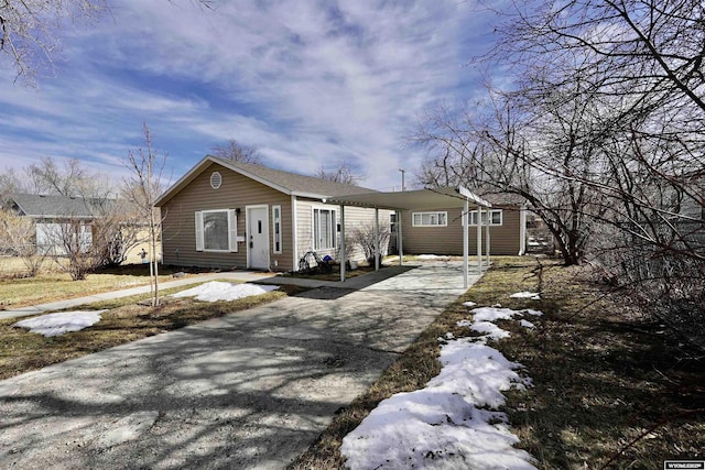 view of front of house featuring a carport and driveway