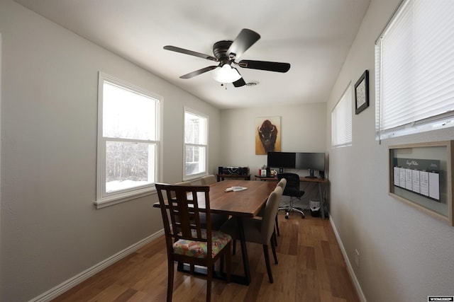 dining room with wood finished floors, baseboards, and ceiling fan