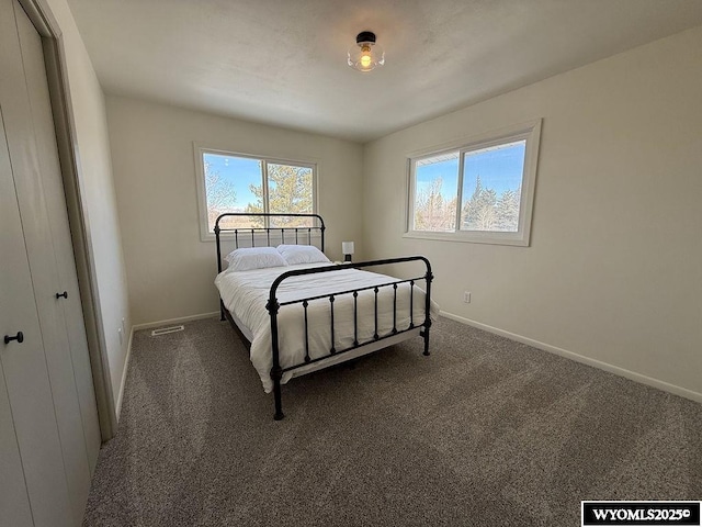 carpeted bedroom featuring baseboards