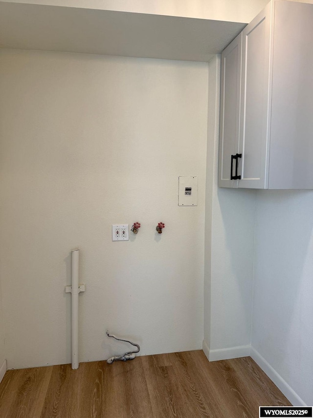 washroom with cabinet space and wood finished floors