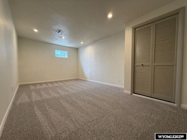 interior space with recessed lighting, baseboards, a textured ceiling, and carpet flooring