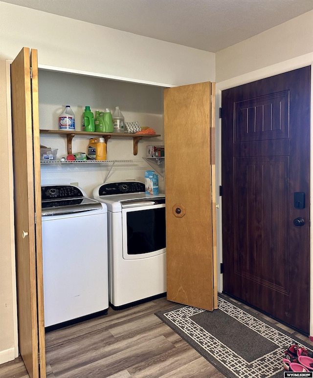 laundry area featuring laundry area, independent washer and dryer, and wood finished floors