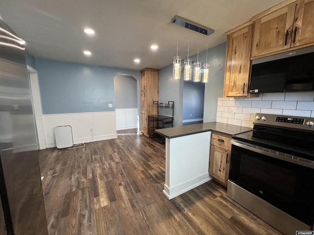 kitchen with dark countertops, black microwave, stainless steel electric range, a peninsula, and arched walkways