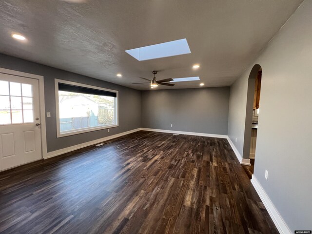 unfurnished room featuring baseboards and dark wood-type flooring