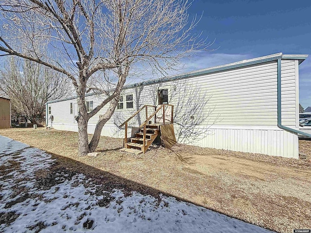 view of snow covered back of property