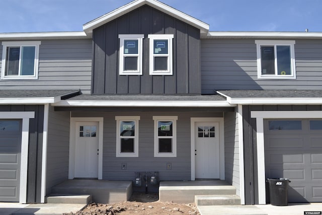 townhome / multi-family property with board and batten siding and a garage