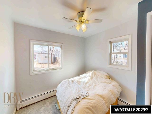 bedroom featuring baseboard heating, a ceiling fan, and carpet floors