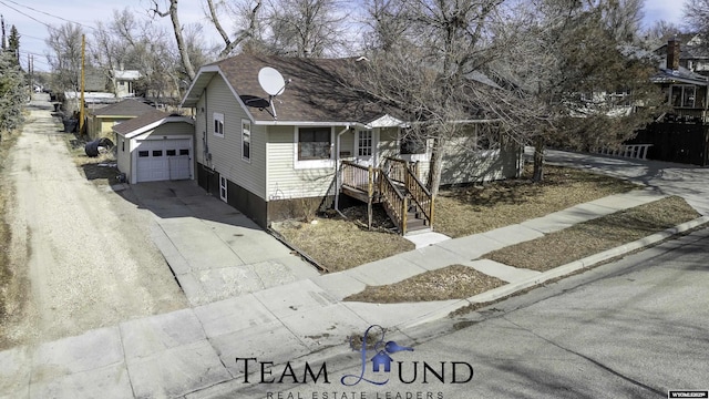 view of front of property with concrete driveway and a shingled roof